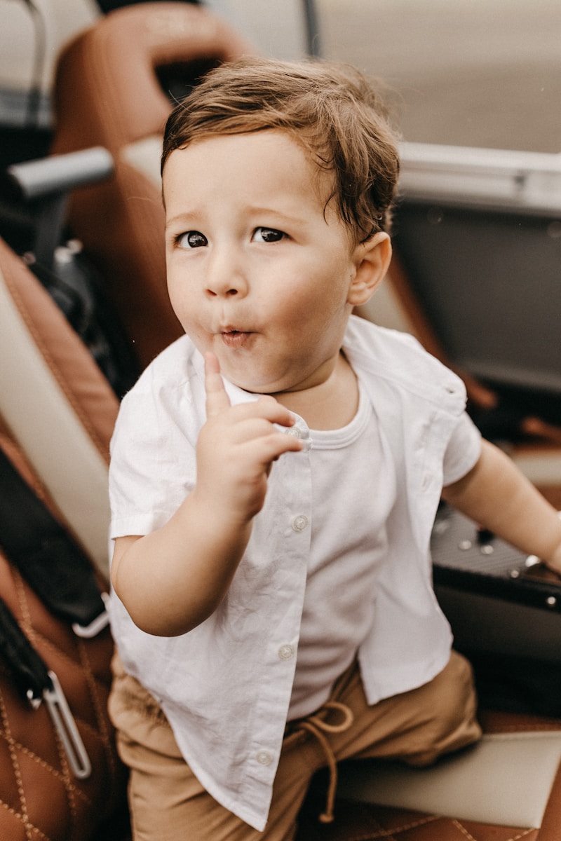 Photo by Jonathan Borba boy wearing white button-up t-shirt, white tank top and brown bottoms