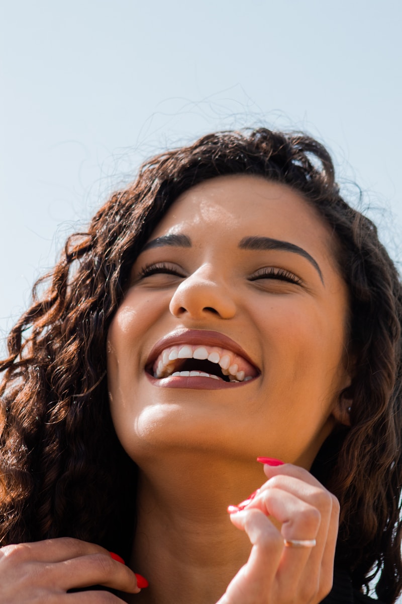 Photo by Street Og' woman with brown hair smiling