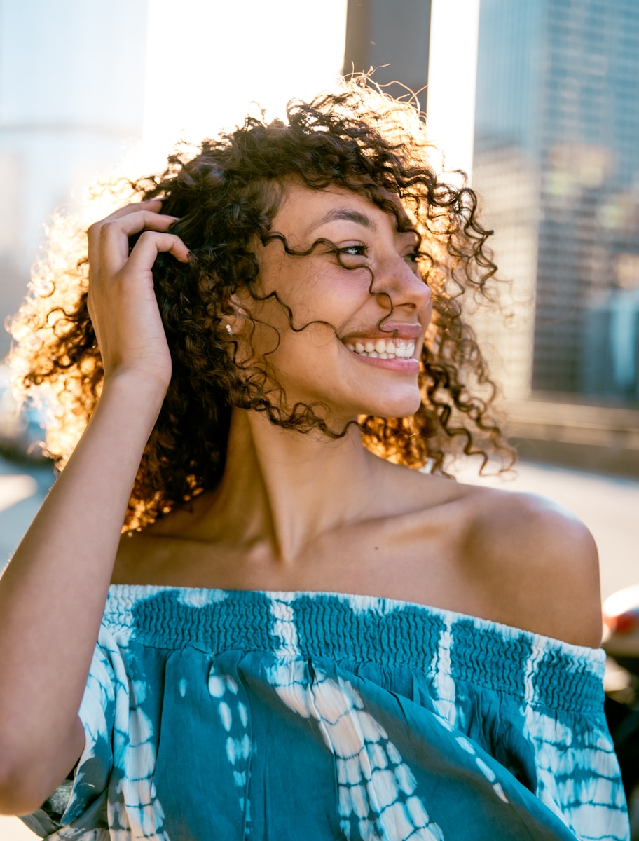 Photo by Steven Aguilar woman in blue tube dress smiling